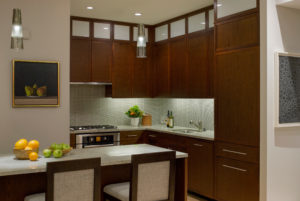Transitional kitchen, waterfall kitchen island, small kitchen ideas, stack bond tile, backsplash, glass tile, modern pendant lighting, recessed kitchen lighting, under cabinet lighting, dark wood cabinets, modern cabinet hardware,