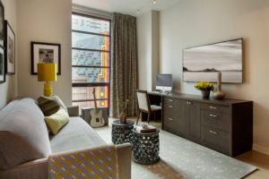 transitional home office,transitional den, ceramic bunching tables, chartreuse punch color, waterfall edge, custom millwork, custom storage unit, tight back sofa, bench cushion on sofa, storage desk,