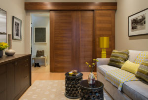 Transitional den, transitional home office, custom millwork, sliding doors, ceramic bunching tables, chartreuse punch color, waterfall edge, tight back sofa, bench cushion on sofa, storage desk, book match