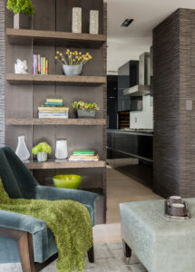 Transitional living room, green, tonal, abstract art, apple green, darkwood, den, living area, custom millwork, floating shelves, contemporary wood paneled wall, lacquer kitchen, mohair chair