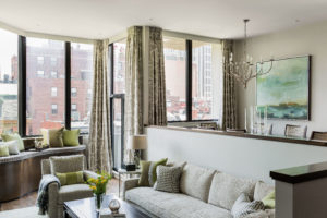 Transitional living room, balcony, picture windows, custom furniture, custom window bench, shared living and dining space, open concept, tonal, chartreuse accent color, green accent color, cream, wall mounted TV, gas fireplace, minimal fireplace surround