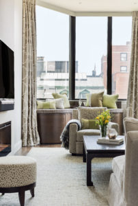 Transitional living room, balcony, picture windows, custom furniture, custom window bench, shared living and dining space, open concept, tonal, chartreuse accent color, green accent color, cream, wall mounted TV, gas fireplace, minimal fireplace surround