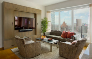 Transitional living room, media cabinet, modern media unit, custom millwork, city view, living space, Boston, large windows, wall mounted TV, textured fabric, subtle upholstery patterns