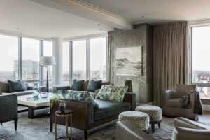 Contemporary glass chandelier, turquoise, textured upholstery, patterned upholstery, darkwood, textured wallpaper, transitional living room, wraparound windows with city view, custom drapery, monochromatic, tonal, recessed lighting, tet a tet, leather lounge chairs, sculpture, subtle patterns, open concept