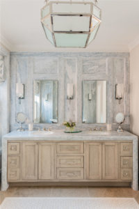 transitional bathroom design, blue stone marble bathroom, calcite azul marble, waterfall edge counter, waterfall edge vanity top, his and hers sinks, marble wall panels, marble casing,