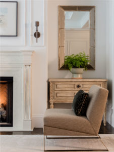 transitional living room, applied wall moulding, wood burning fireplace, transitional fireplace surround, neutral color palatte living room, wall niche, floor legnth drapery, custom drapery, transitional wall sconces, bronze wall sconce