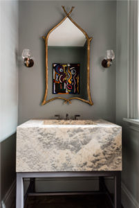 Carved stone vanity, custom sink, transitional wall sconces, gold decorative mirror, abstract art, transitional bathroom