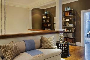 transitional home office, transitional family room, loft space, ceramic end table, custom built office furniture, minimalist bookshelves, open bookcase, swing arm desk lamp, wall mounted desk