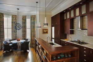 transitional kitchen design, kitchen island storage, contemporary stainess steel range hood, subway tile backsplash, wrought iron cage pendant, globe pendant, transitional dining room table, eat in kitchen