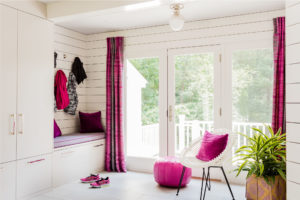 White millwork, shiplap wall, horizontal wall panels, mudroom, custom built in mudroom storage, pops of pink, fushia accents, Moroccan Pouf,