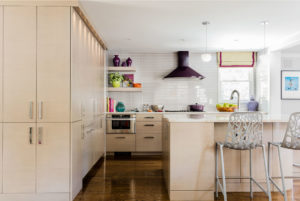 Purple hood, eggplant purple hood, grey subway tile backsplash, contemporary kitchen island, colorful accents, fun kitchen, open kitchen shelving, fully integrated refrigerator,