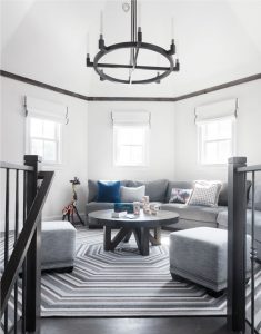 Uniquely shaped room, hexagon shaped rug, custom designed rug, reclaimed wood crown moulding, transitional family room, roman valances, transitional iron chandelier,