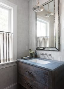 Soapstone vanity top, rustic wood vanity, reclaimed wood vanity, wall mounted faucet, café curtain, antique mirror, textured subway tile, three dimensional subway tile,