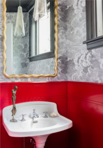 cloud wallpaper,glass pendant,gold mirror,gray trim,lacquered walls,pedestal sink,red walls,textured wallpaper