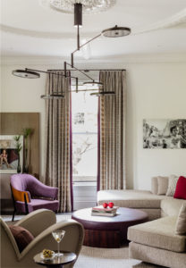 black and white photography,colorful artwork,crown moulding,flat panel millwork,modern artwork,modern chandelier,sectional sofa,statement color,Transitional Drapery,transitional millwork