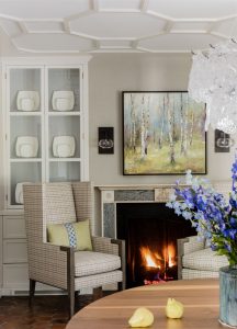 decorative ceiling moulding, applied ceiling moulding, built in hutch, built in dining room storage, fireplace in dining room, high back lounge chair, birch tree painting, transitional dining room design