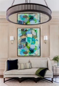 transitional living room, contemporary chandelier, aged iron chandelier, transitional chandelier, applied wall moulding, contemporary art, abstract art, transitional wall sconces, transitional settee, neutral settee