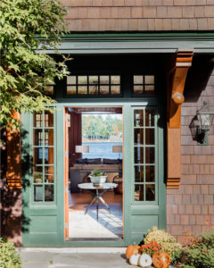 modern rustic home, lakehouse exterior, stained shingles, green exterior trim, green front door