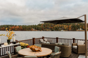 Entertaining porch, lakehouse exterior view, transitional outdoor furniture, outdoor dining set, upholstered outdoor sofa, outdoor pillows, upholstered outdoor dining chairs,