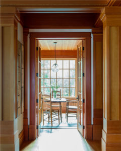 wood paneled ceiling, contemporary ceiling pendant, sunroom, wrapped interior columns, interior decorative columns, wood paneled walls, wood moulding, modern rustic lakehouse, transitional lakehouse design