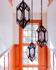 transitional lakehouse, oversized interior lanterns, aged iron lanterns, wood peneled walls