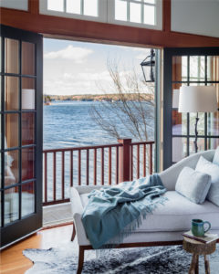 Lakehose, lakeside view, hide rug, upholstered chaise lounge, master bedroom balcony, rustic end table, modern rustic lakehouse, french door bedroom balcony, french door to balcony