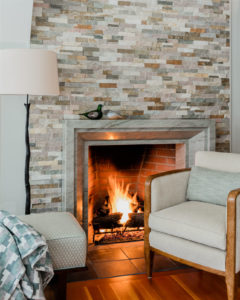 lakehouse,transitional living room furniture,relaxed living room,stone fireplace surround, transitional fireplace surround, wood flooring