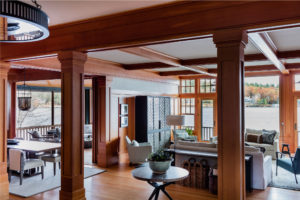 modern rustic lakehouse, transitional living room, interior decorative columns, wrapped columns, entryway furniture,lakehouse,lakeside view,living room furniture,picture windows,relaxed living room,stained moulding,warm wood,wood panel wall,wood paneling