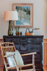 transitional lakehouse, antique chest of drawers, distressed furniture, rustic rocking chair