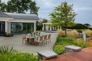 Modern poolhouse exterior, transitional poolhouse, oceanside poolhouse, contemporary outdoor dining furniture, in ground pool