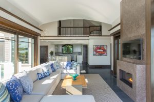 contemporary poolhouse, two story fireplace, contemporary fireplace surround, transtional scetional sofa, in ground pool, transitional family room