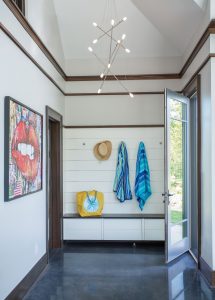 transitional mudroom design, contemporary chandelier, white shiplap, horizontal wall boards, dark wood moulding, transitional poolhouse design