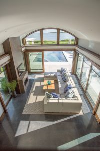 contemporary poolhouse, ocean view living room, two story fireplace, contemporary fireplace surround, transtional scetional sofa, in ground pool, transitional family room