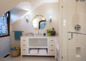 transitional bathroom design, round vanity mirror, glass shower door, café curtain in bathroom, custome bathroom vanity with storage, white shower tile