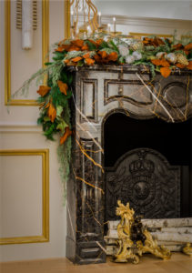applied moulding,Fireplace,gold accents,holiday decoration,living room,marble fireplace,gold accents,gold wall moulding,antiques,ornate