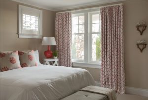 transitional guest bedroom, subtle beach theme, coral accents, coral print pillows