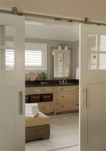 En suite master bathroom, contemporary barn door hardware, his and her sinks, dual sliding barn doors, modern rustic bathroom, subtle beach theme bathroom, transitional bathroom