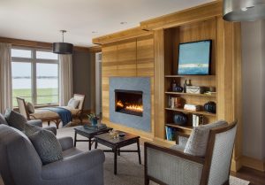 bunching tables,contemporary fireplace surround,custom millwork,gas fireplace,integrated shelving,ocean view,window bench,wood fireplace