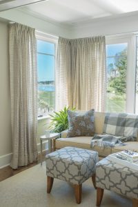 Transitional sittting area, neutral living room, blue patterened upholstered ottomans, beach house living room, New England beach house family room