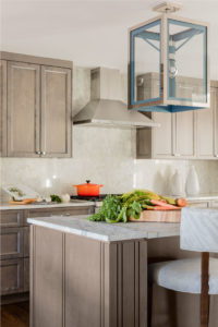 geometric pendant light, kitchen island, large pendant light, oversized lantern pendants, stainless steel range hood, statement lighting, transitional kitchen, gray stained cabinets