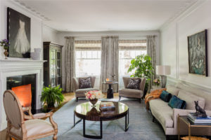 Transitional living room, updated Boston, Brownstone, applied moulding, original crown molding, laquered wood round coffee table, wood burning fireplace